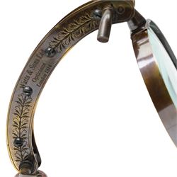Magnifying glass on wooden stand