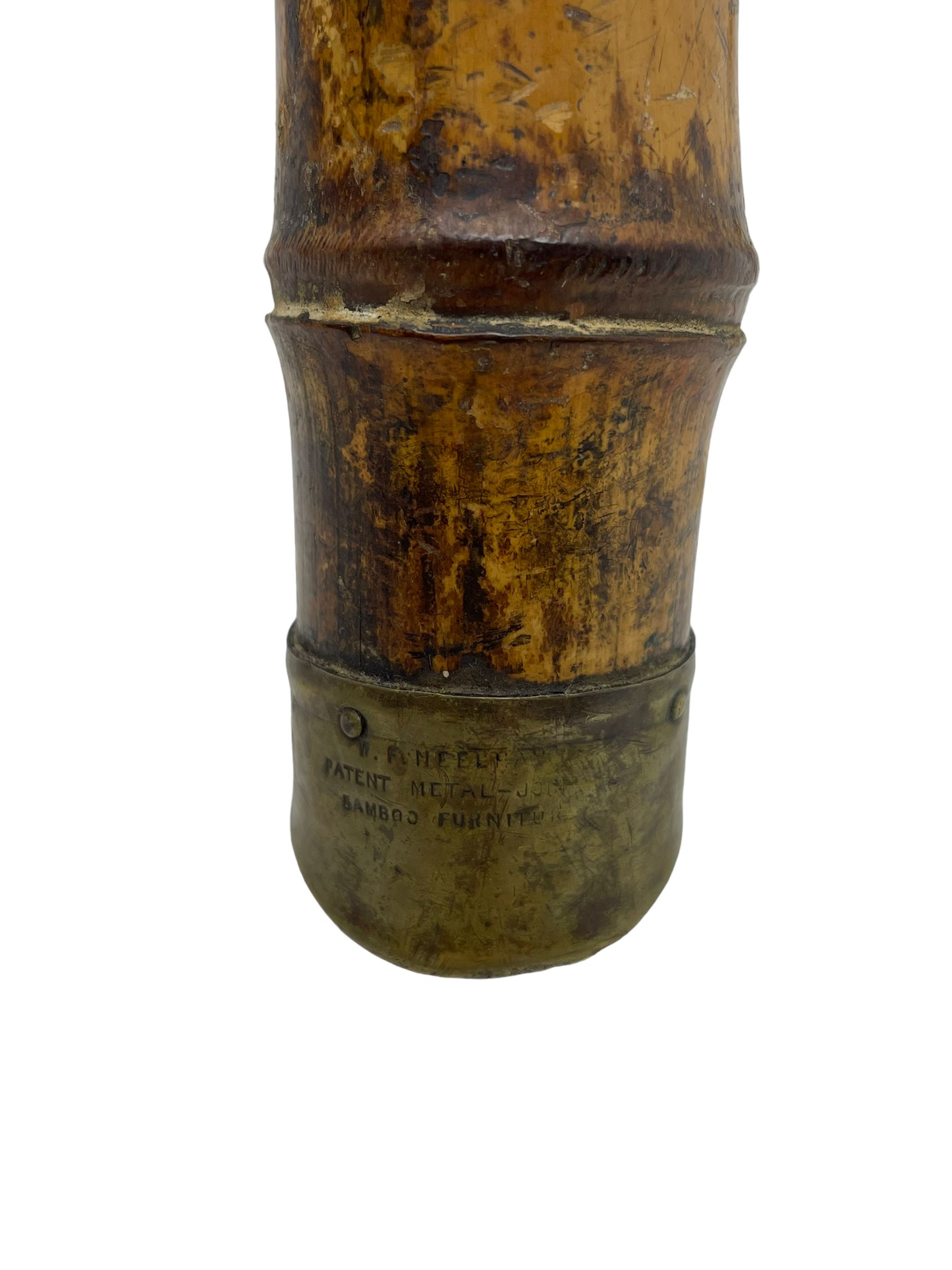 W.F. Needham - Victorian bamboo occasional table, octagonal lacquered top, the bamboo joined by metal brackets, brass cups stamped 'W.F Needham'