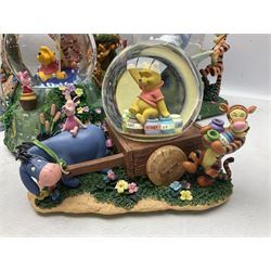 Five Disney Winnie The Pooh snow globes to include The Rain Rain Rain Came Down Down Down, Eeyore Pulling Cart, Owl's House, Rumbly in My Tumbly and Stuck In Rabbit's House, together with figure group with dome, five with boxes (6)