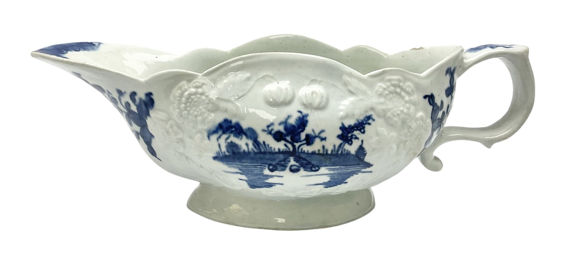 Large 18th century Lowestoft sauce boat, circa 1770, the body decorated with Hughes type floral moulding, and painted in underglaze blue with an Oriental landscape, and foliate sprigs, L23cm