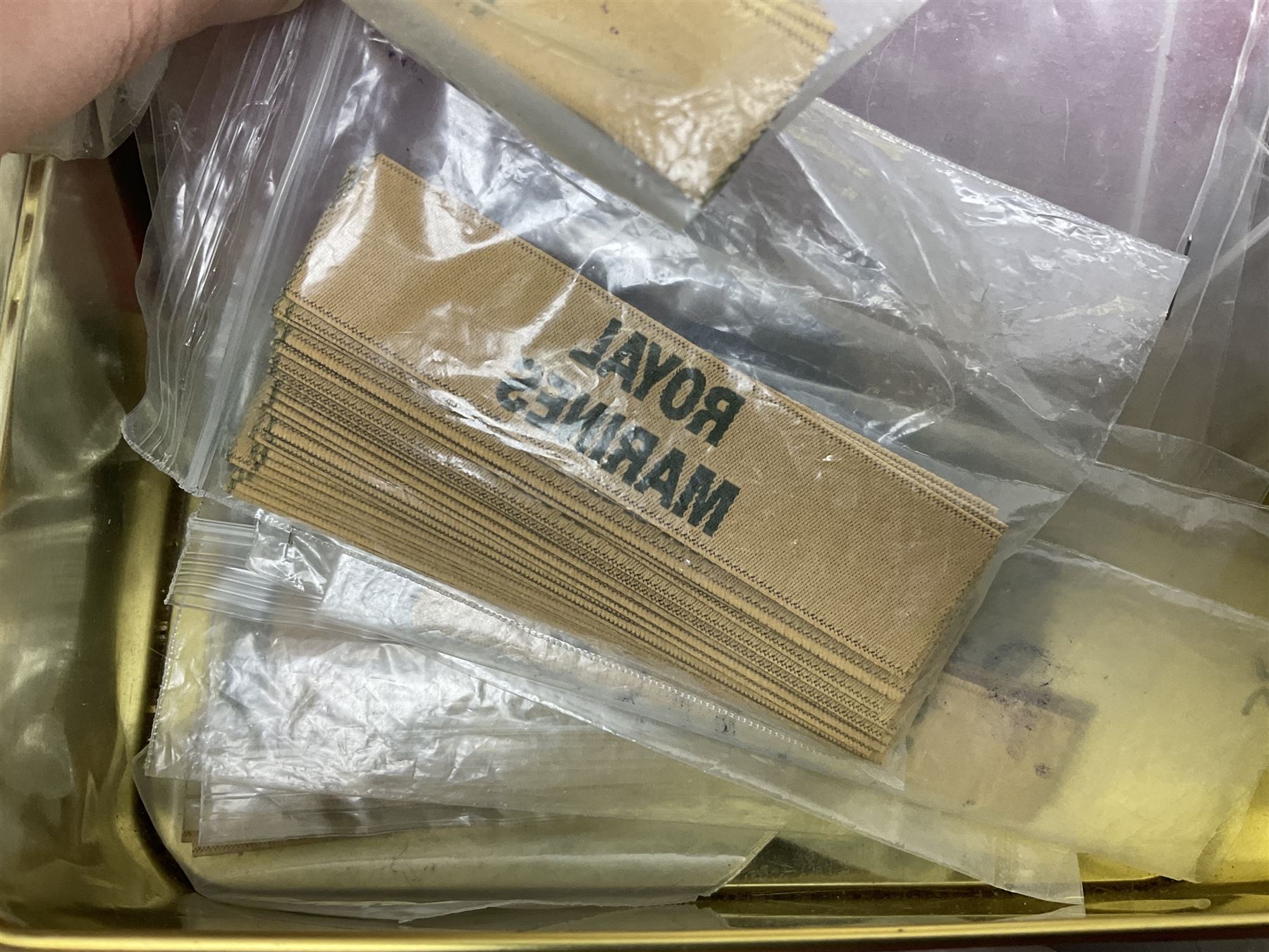 Quantity of military horse hair plumes and feather hackles, cloth stripes and regimental titles etc