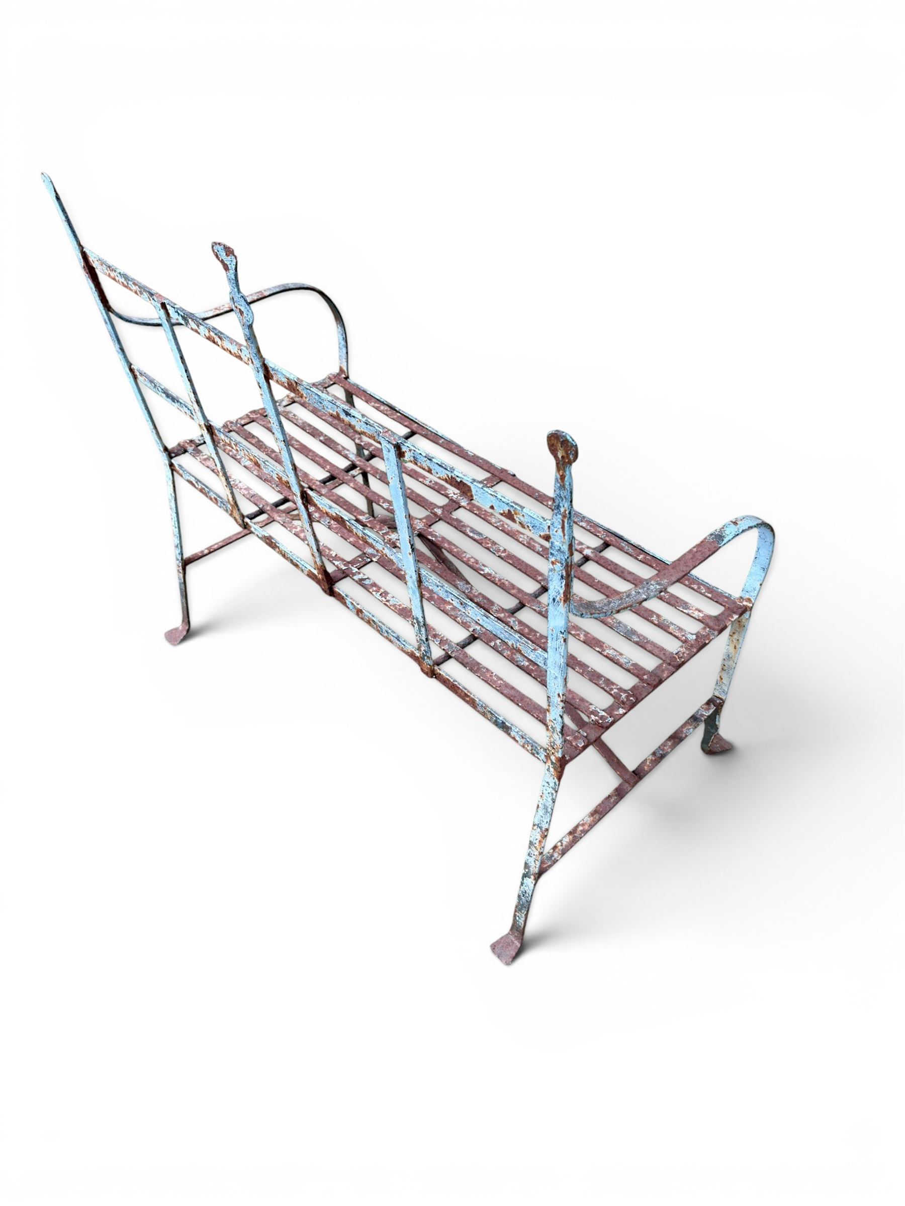 Regency period wrought iron strapwork garden bench, cresting rail with central Scottish thistle motif and flanking pediments, in distressed blue painted finish