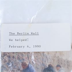 Fragment of the Berlin Wall, largest piece with blue paint to one side, with photograph and sticker to bag dated 1990