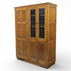 Edwardian oak glazed cabinet, moulded cornice above a panelled front and sides, fitted wit...