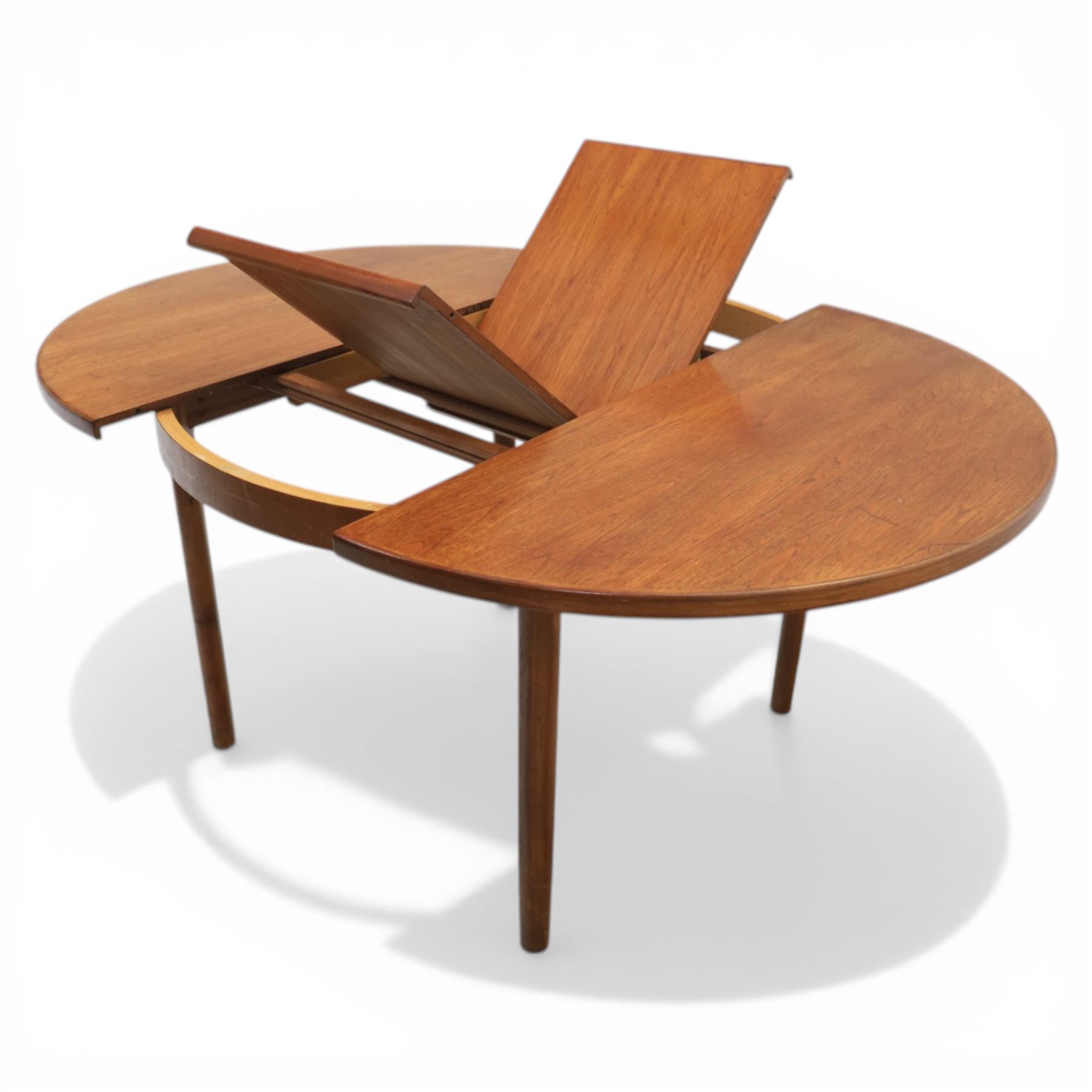 A H McIntosh & Co of Kirkcaldy - teak circular top with moulded edge enclosing butterfly leaf extension, raised on four tapering supports, extending action revealing central leaf, 167cm fully extended