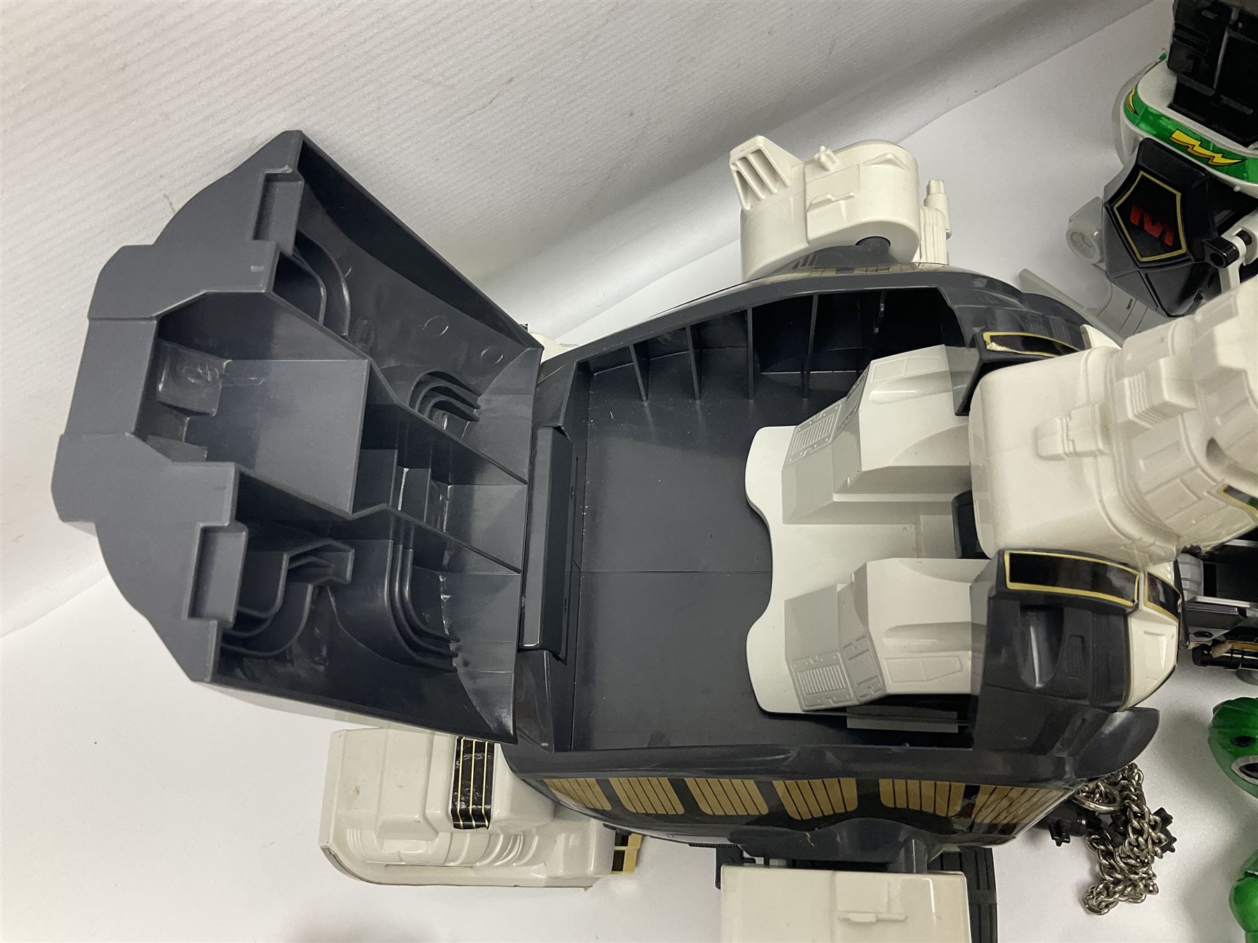 Collection of early 90s Mighty Morphin’ Power Rangers Zords, figures and accessories. Titanus the Carrier Zord, marked Bandai 1991; Green Dragonzord, incomplete; 1994 White Tigerzord with original instruction manual; 1993 Triceratops Dinozord, Mastodon Dinozord and Sabertooth Tiger Dinozord, Pterodactyl Dinozord, missing guns; with 1993 Power Morpher and original Power Coins, with further related figures, accessories and weapons