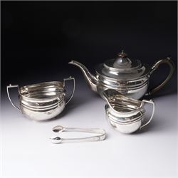 Silver three piece tea set of oval form, the teapot with ebonised handle and lift London 1...