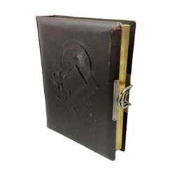 Victorian leather bound photo album, the interior leaves containing apertures of various sizes and shapes of portraits surrounded by printed floral designs, H28cm