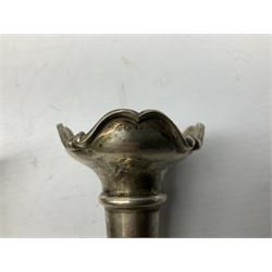 Four hallmarked silver trumpet vases, total weight 108g, upon silver plated stand with foliate decoration and bun feet