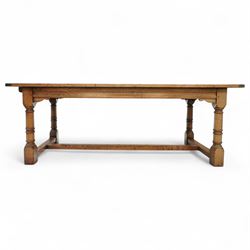 Late 20th century oak refectory table in 17th century style, with plank top and end leaf, raised on ring turned baluster legs with square feet, joined by conforming stretchers (260 cm extended)