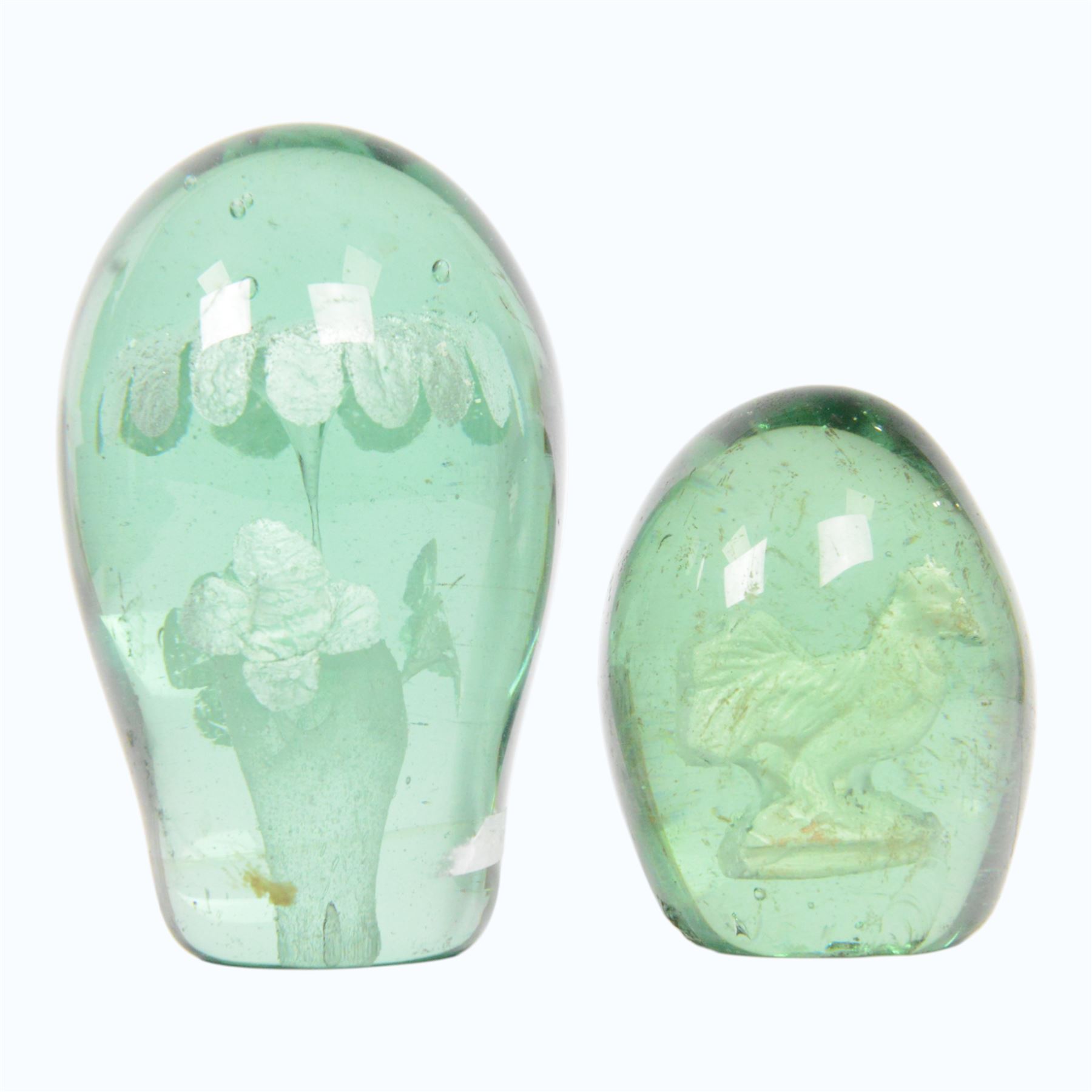 Two 19th century green glass dump paperweights, each of globular form, the smaller example with internal sulphide cockerel, H9cm, the larger with internal sulphide floral bloom, H13cm