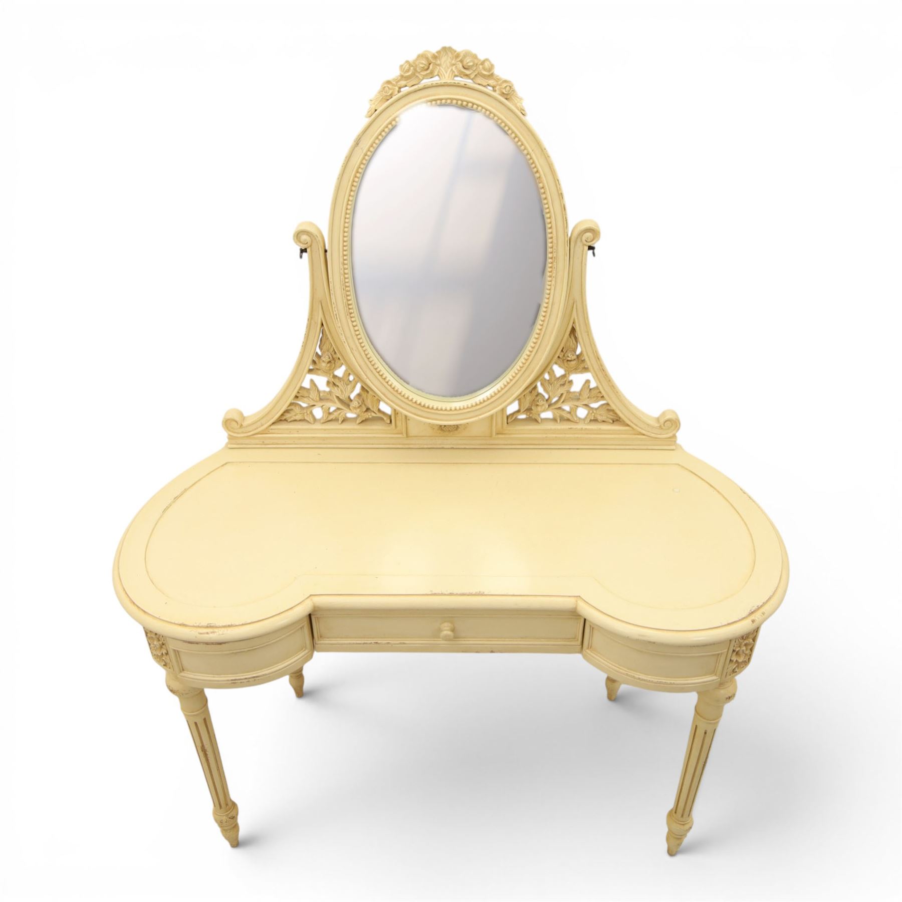 French Louis XV design cream painted dressing table and matching stool, kidney shaped top, with tilting oval mirror, carved uprights raised on fluted and turned supports 