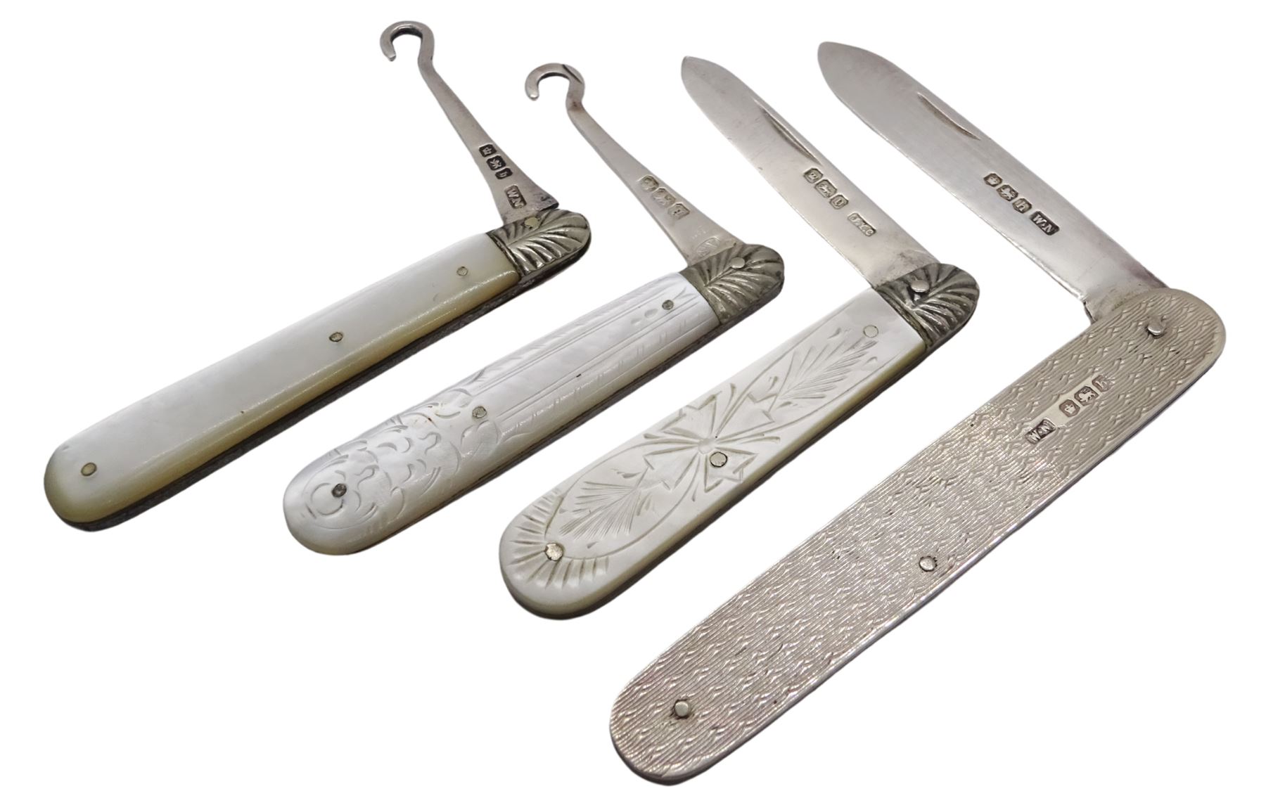 20th century silver fruit knife with engine turned decoration, the blade and handle hallmarked William Needham, Sheffield 1925, together with an Edwardian silver and mother of pearl fruit knife, the handle with engraved detail, the blade hallmarked John Yeomans Cowlishaw, Sheffield 1906, and two late Victorian silver and mother of pearl button hooks, hallmarked Arthur Worral Staniforth, Sheffield 1893 and William Needham, Sheffield 1900, (4)