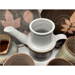 Wold studio pottery tankards, in various colours and relief decoration together with other studio items including vases, jugs and pots 