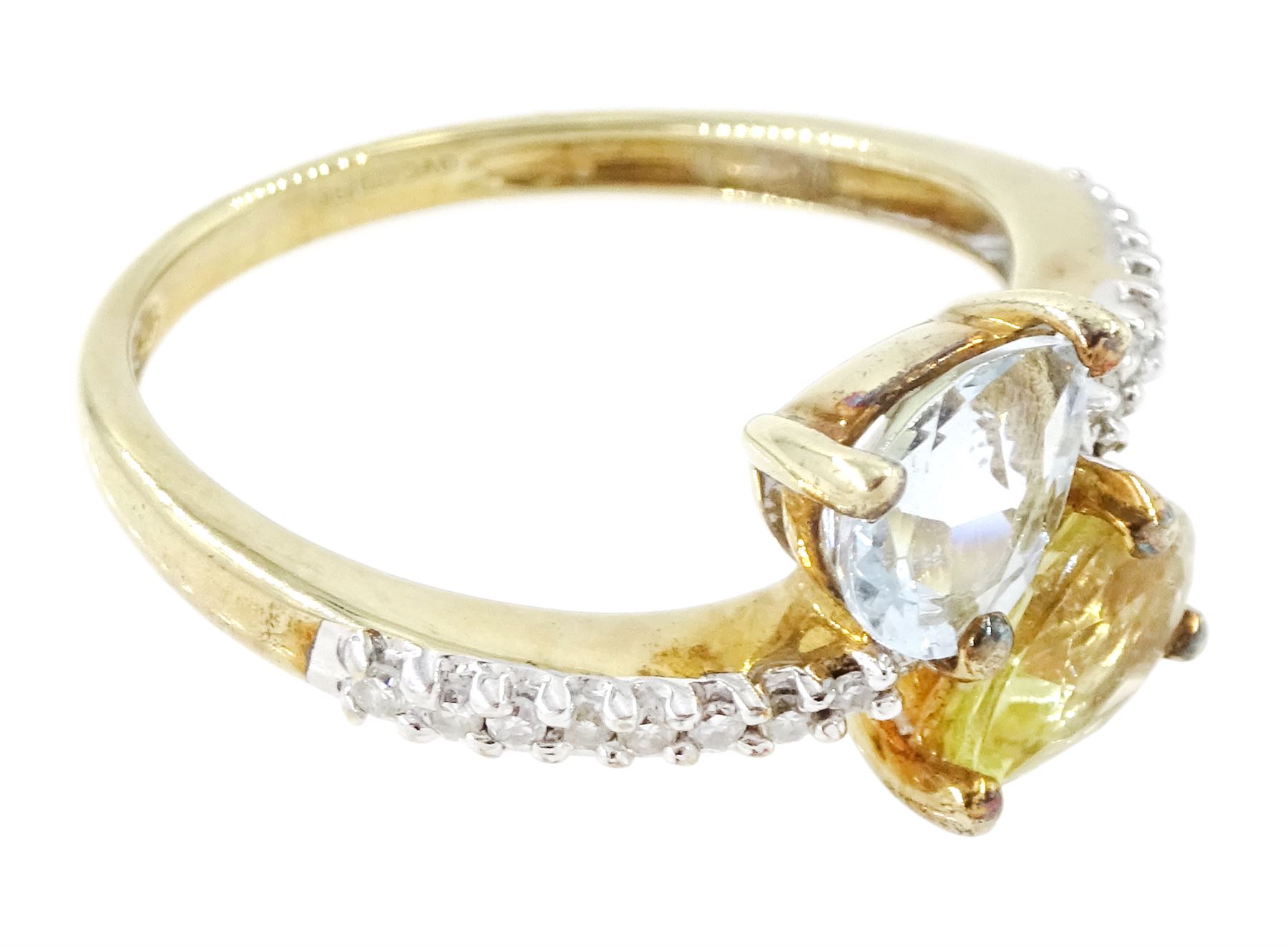 9ct white gold quartz, aquamarine and diamond crossover ring, single pear cut aquamarine and yellow / green quartz, with diamond set shoulders, Birmingham 2004