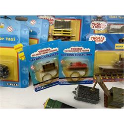 Ertl Thomas the Tank Engine and Friends die-cast models including carded Scrap Trevor, Slate Trucks, Neil, Wilbert, Sodor Taxi, Sodor Recovery Unit, Crane and four key rings; together with various uncarded models including locomotives, coal wagons, steam rollers, boat transporter, recovery units etc (over forty items)