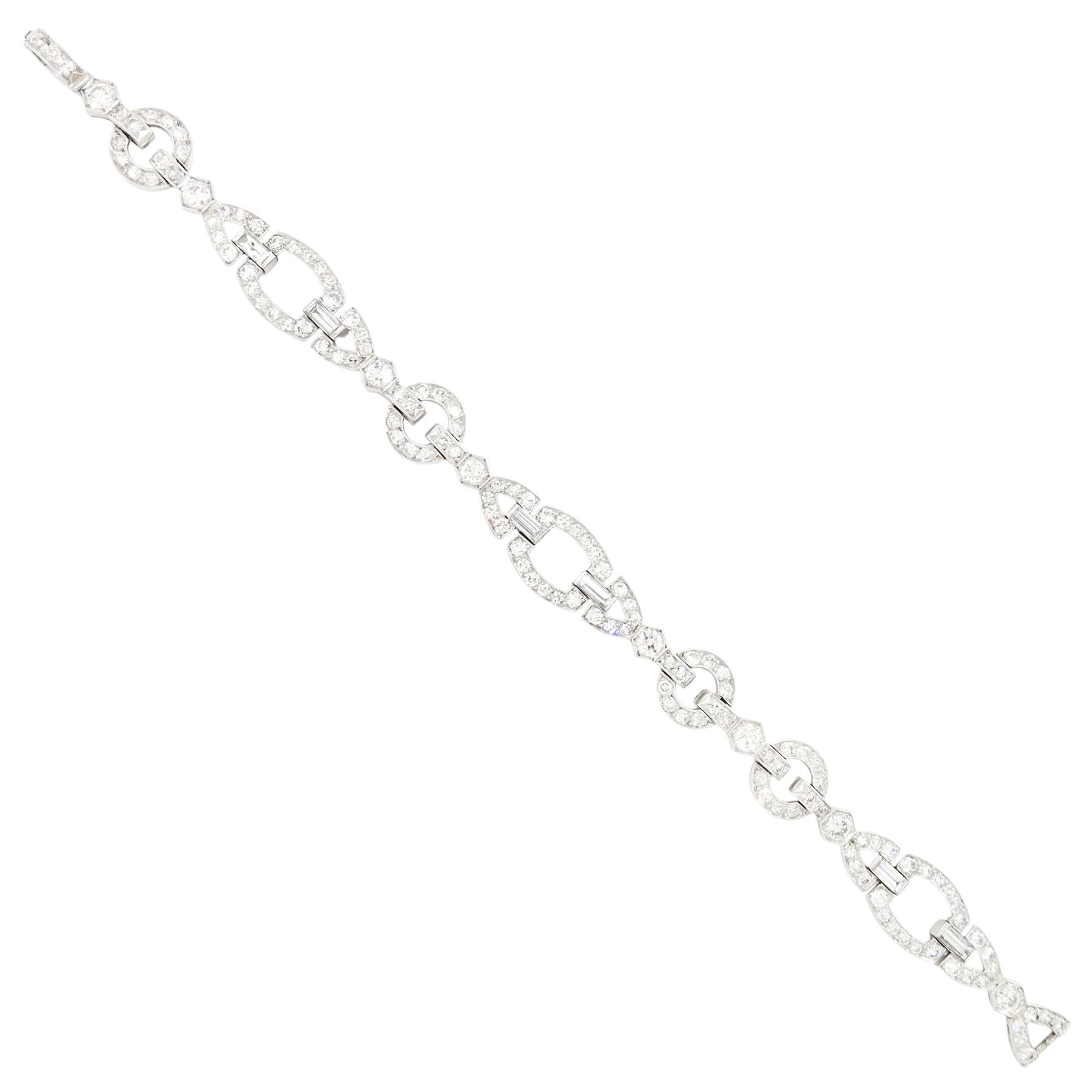 Art Deco platinum diamond bracelet, circa 1920, articulated openwork circular and geometric links, milgrain set with old cut diamonds and baguette cut diamonds, total diamond weight approx 3.85 carat