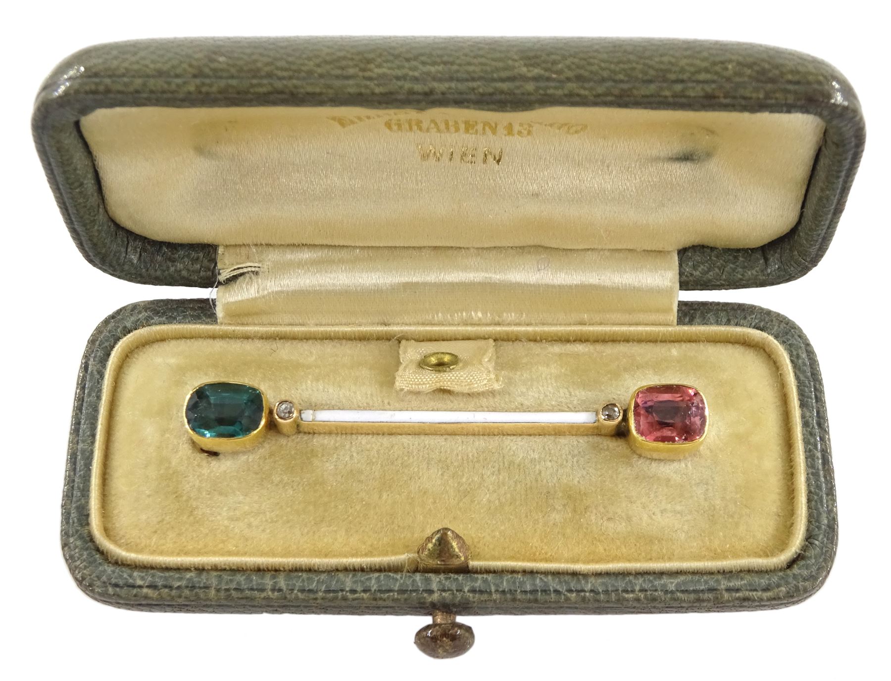 Early 20th century Austrian 14ct gold tourmaline, diamond and white enamel bar brooch, each end set with a green and pink tourmaline and a single stone diamond chip, by Ernst Paltscho (Vienna 1858-1929) hallmarked, in original fitted silk lined box 