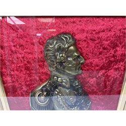 Late 19th/early 20th century cast brass head and shoulder profile of Wellington mounted with named brass banner on a red velvet ground in an ornate gilt frame within a glazed ebonised display case; bears labels verso for Maull & Fox 187a Piccadilly London W. 52 x 44cm overall