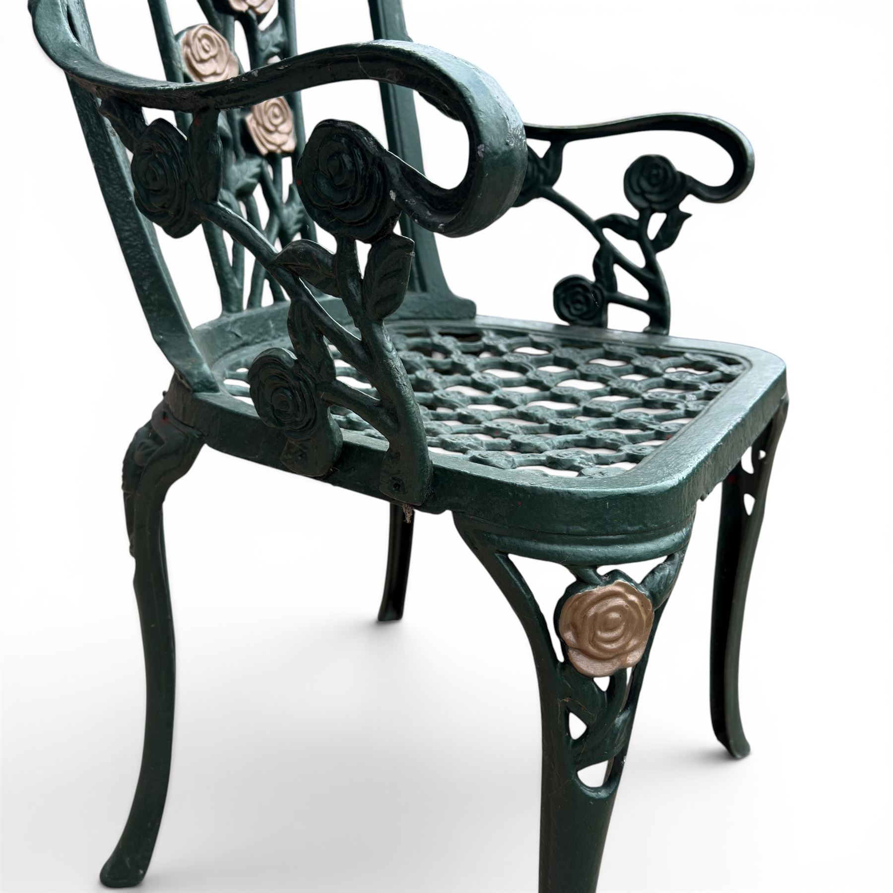Cast aluminium oval garden table and set of four armchairs with pierced rose design back splats