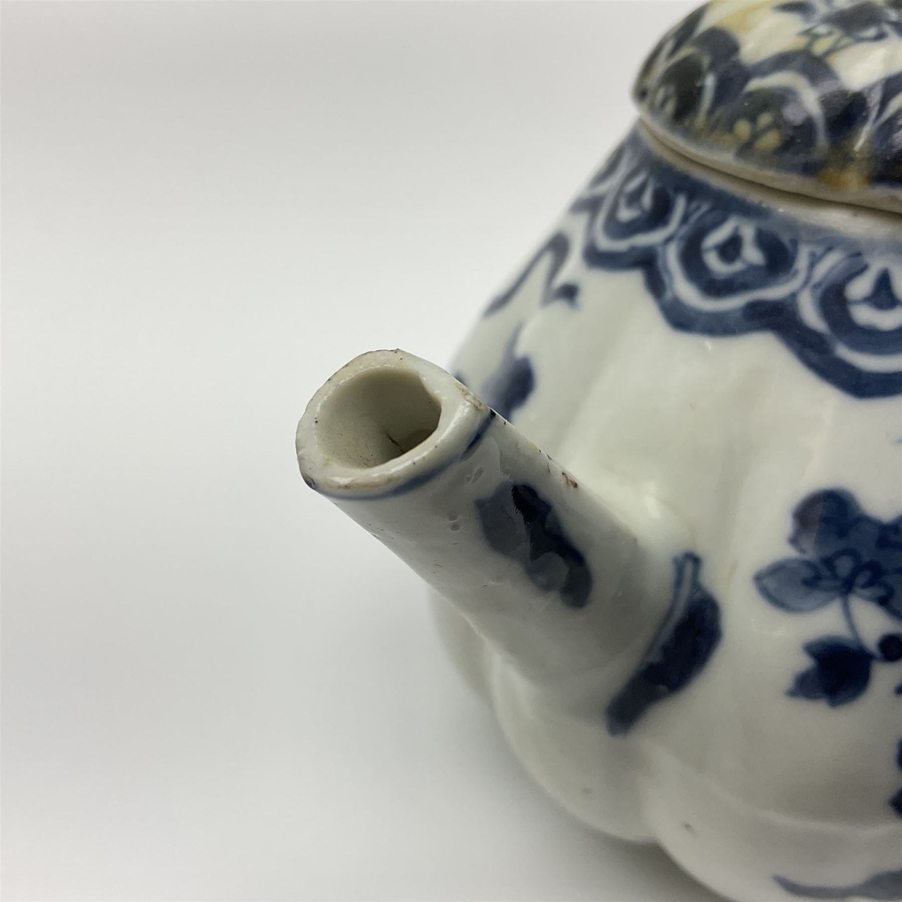 18th century Chinese blue and white teapot, painted with floral sprays, with lobed body and cover, H11cm