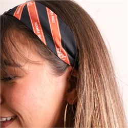 Hermès - two ‘Bolduc’ silk Twilly scarves, in orange/black and navy/brown colourways, together with three palladium-tone Médor pyramid Twilly scarf rings, with original dust bag and cylindrical box