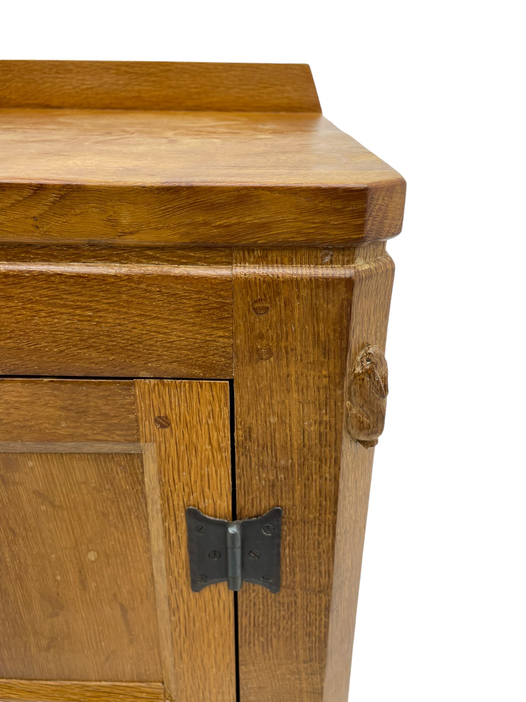Rabbitman - adzed oak sideboard, fitted with three central drawer and two flanking cupboards, panelled doors with iron latches and hinges, carved with rabbit signature, by Peter Heap, Wetwang