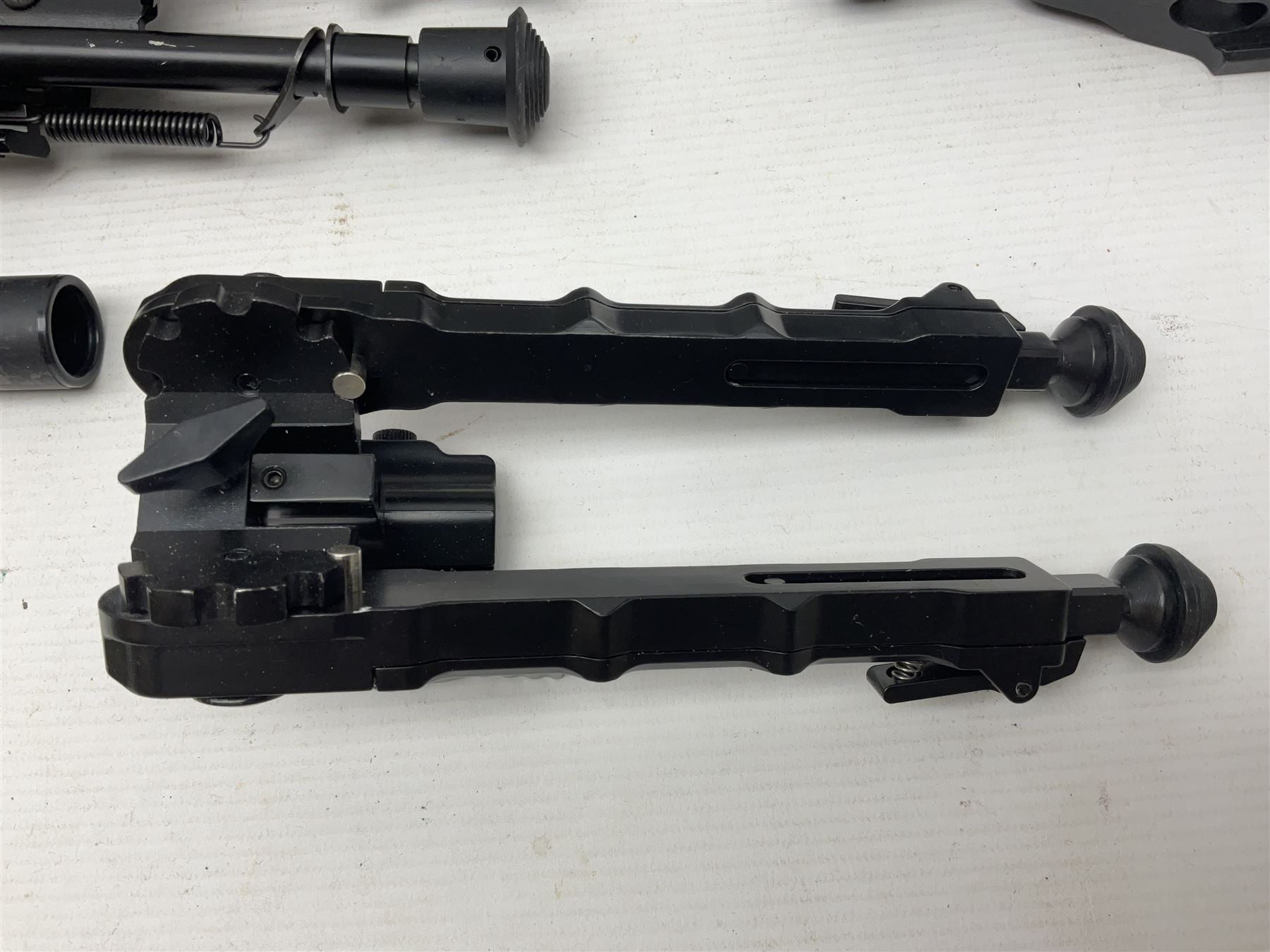 Assorted shooting accessories including two telescopic sights, red dot sight,  two bi-pods, spirit level mount, two gun butts and two forward handles