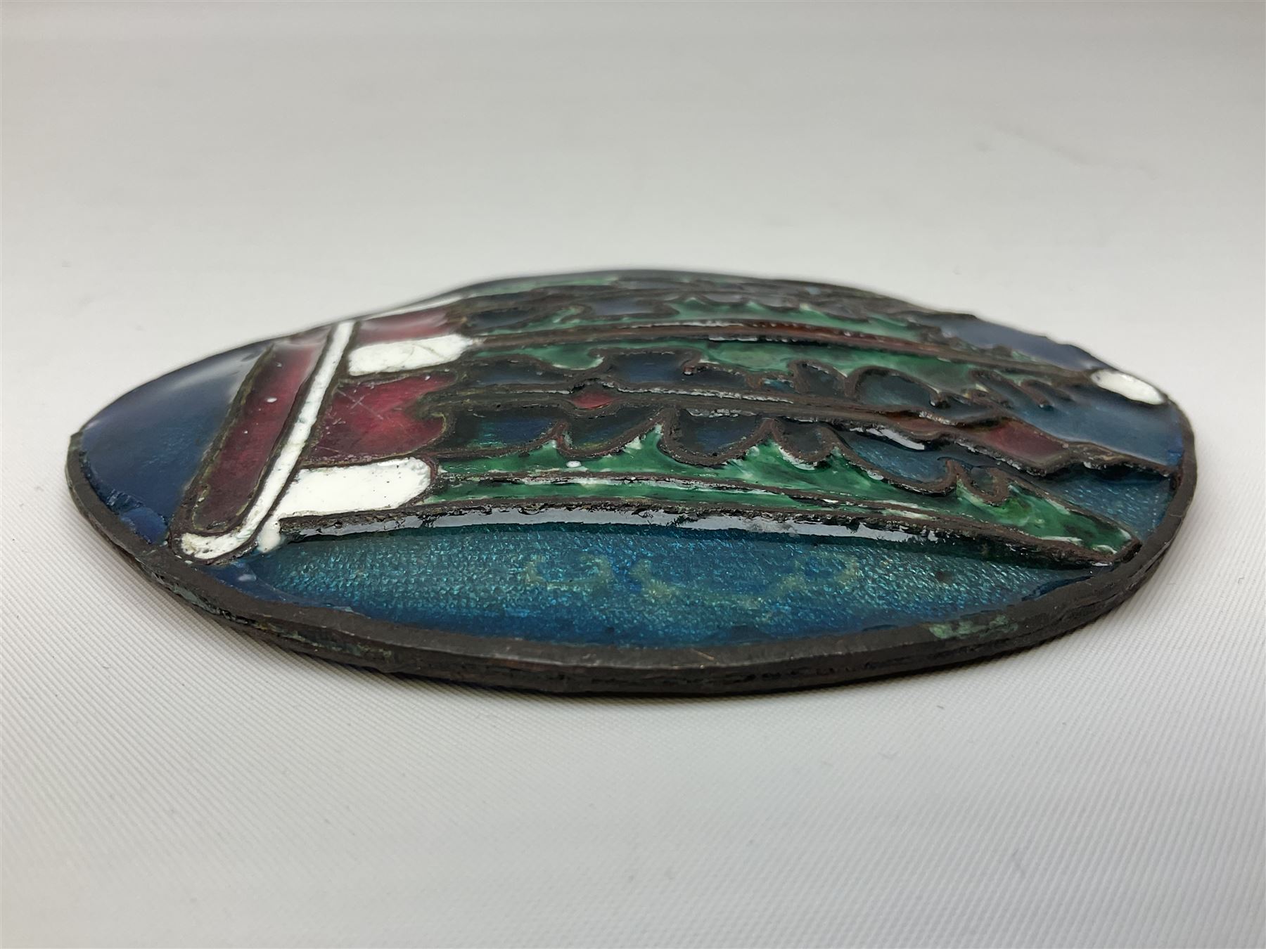 Henry George Murphy (1884-1939), Arts & Crafts enamel panel, of bulbous elliptical form decorated with a stylised crown in green, red and white, upon a turquoise toned ground, H12cm W9cm