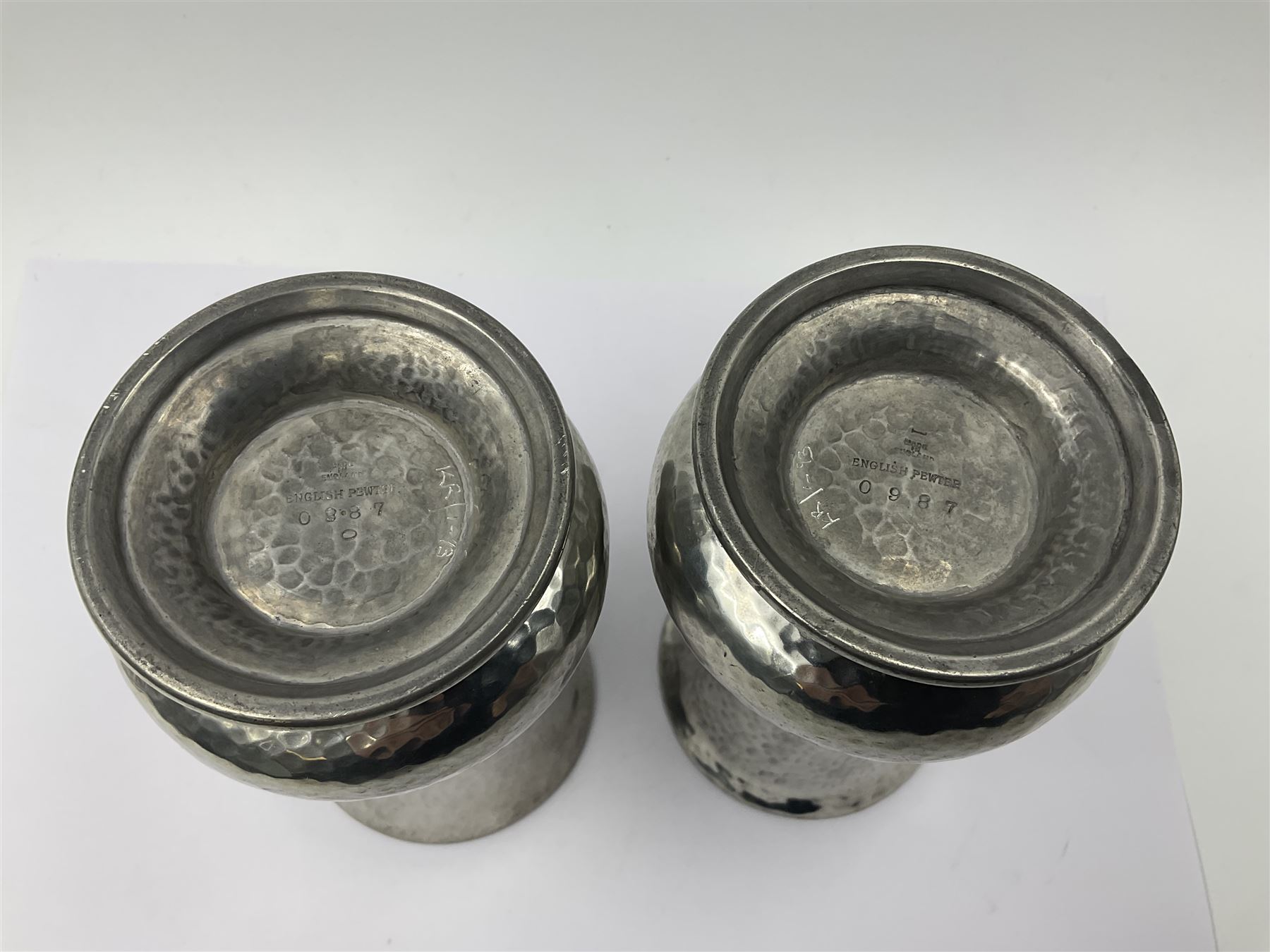 Pair of Liberty & Co Tudric pewter vases, each of bellied form with hammered finish, upon a circular spreading foot, impressed beneath 0987, H12cm