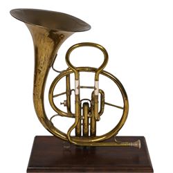 Boosey & Co Ltd French horn, converted into a table lamp, upon a wooden plinth, H45cm