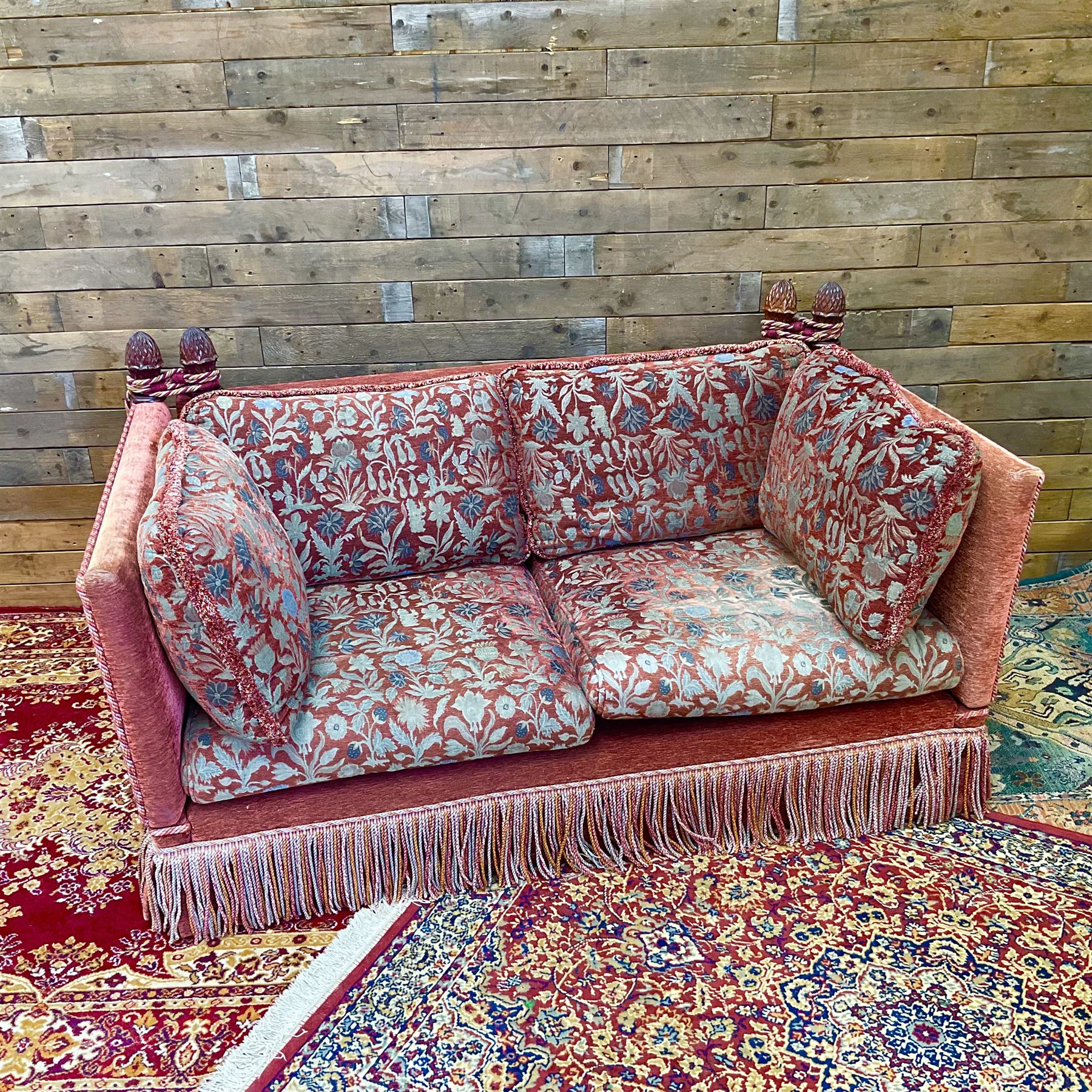 Knole type drop arm sofa with cushions in a traditional patterned upholstery,