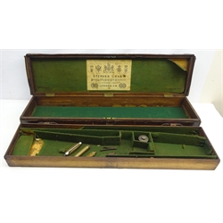  Late 19th/early 20th century leather bound oak shotgun case with brass corners, lift out fitted green interior to take barrel up to 31ins, with oil can etc, lid with trade label for Stephen Grant of 67A St. James Street, London, W86cm, D22cm, H12cm  