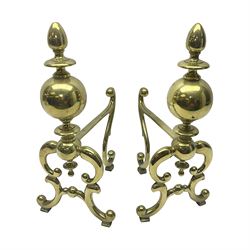 Pair of early 20th century brass fire dogs, each with sphere and urn finial, upon a scrolling base, H38cm