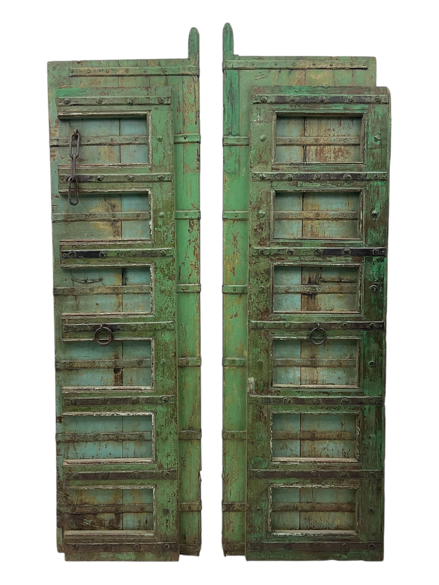 Pair of green-painted Indian doors, c.1860–1880, made from solid teak featuring original iron work and hand-painted finish
