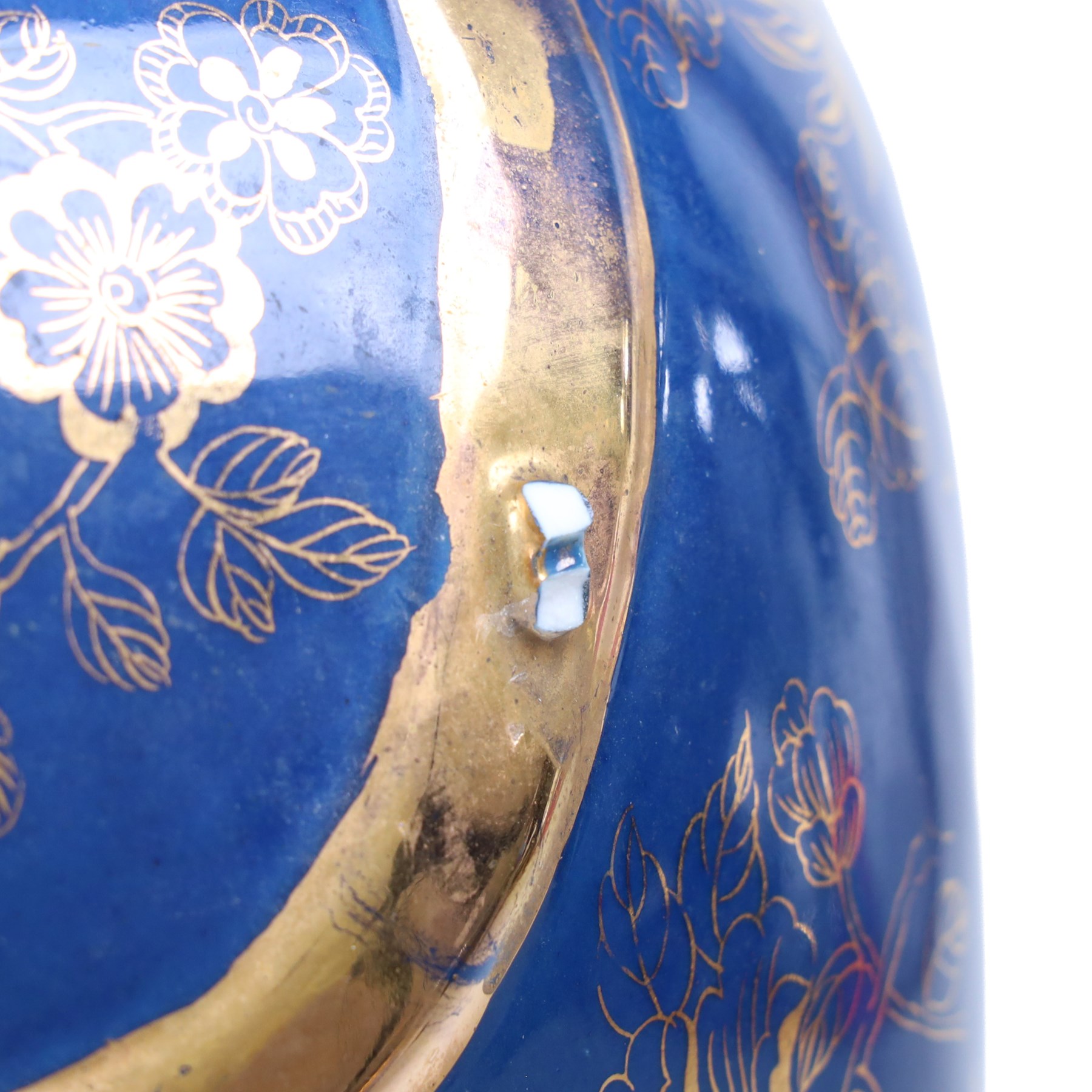 Pair of 20th century foo dog incense burners, decorated with gilt flowers and insects upon a blue ground, on wooden stands, H58cm 