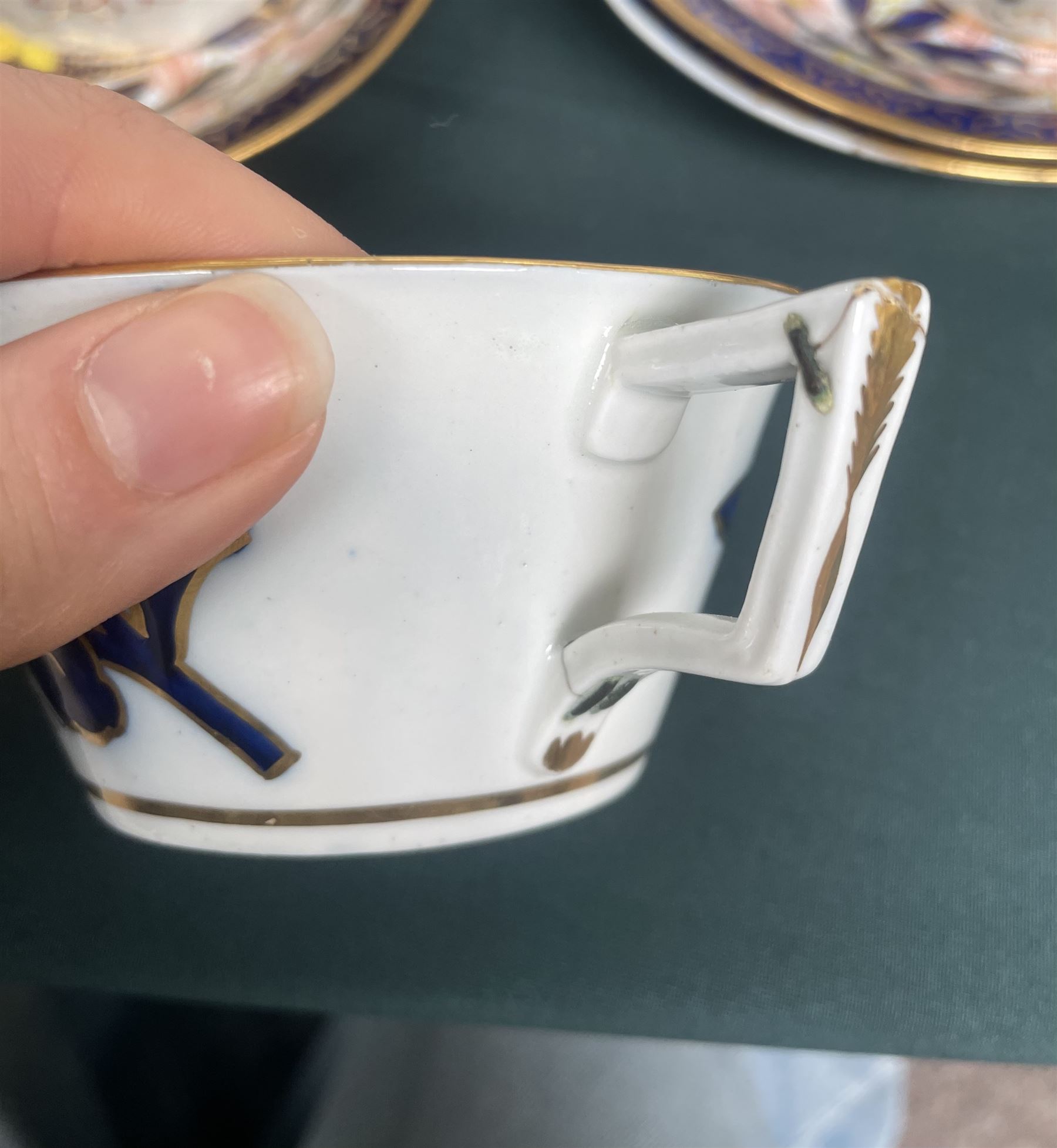 English porcelain Imari tea and coffee wares, pattern 1277, decorated with central orange floral motif surrounded by sprigs of yellow foliage within blue borders, comprising eleven teacups, eight coffee cups, twelve saucers, two shallow bowls and one finger bowl