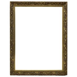 Art Nouveau design gilt framed wall mirror, rectangular bevelled plate, the frame decorated with lotus and lilypad motifs amongst stylised reeds