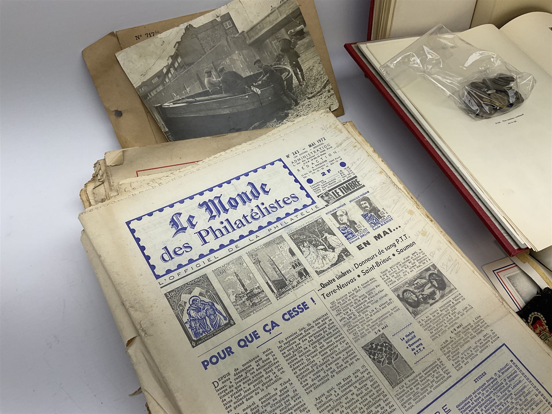 Great British and World stamps in two albums including a small number of Queen Victoria penny red stamps, small number of coins and various items of militaria interest