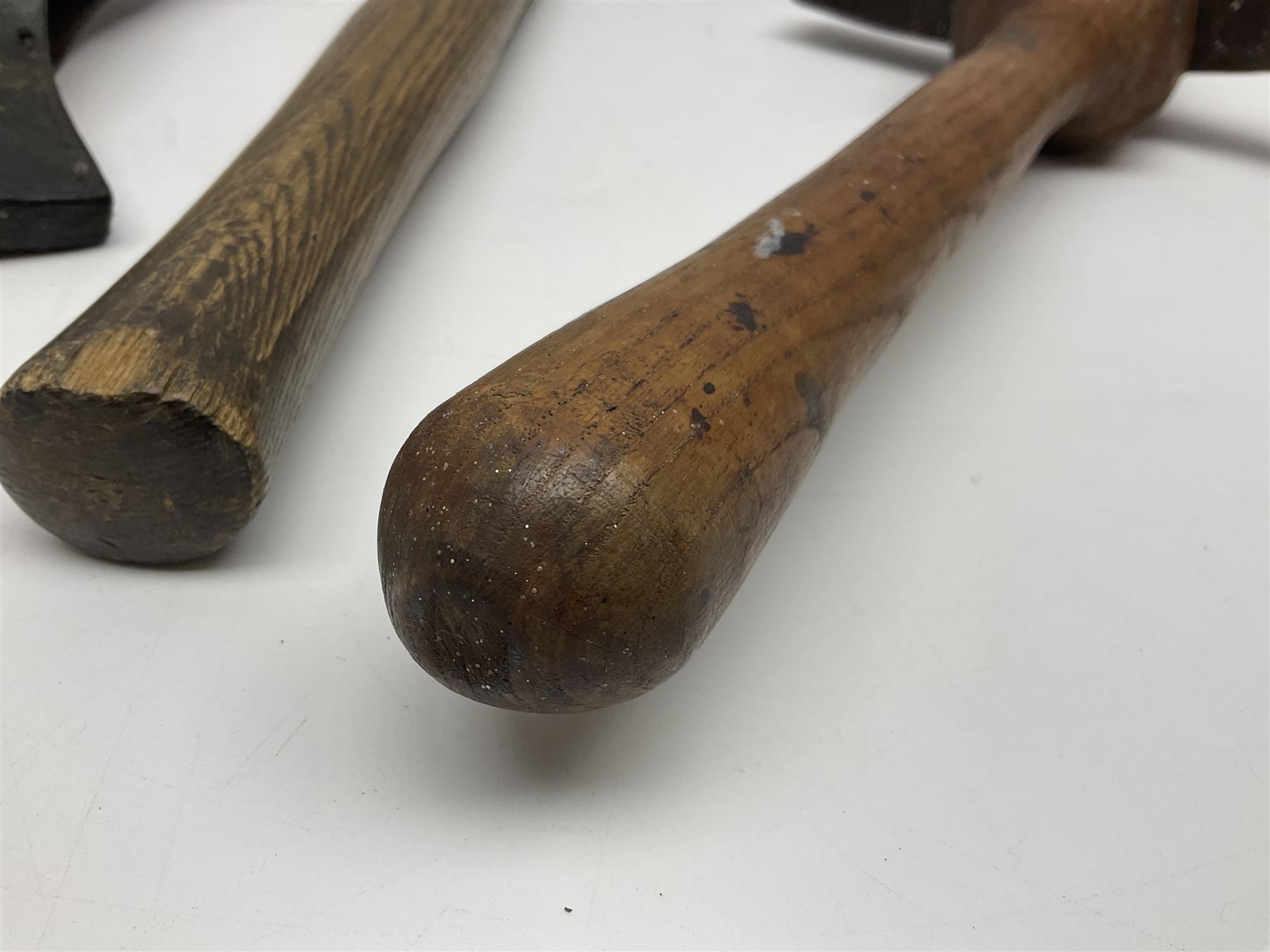 Post-War military type fireman's axe impressed 'PERKS 1953/54' with additional indistinct mark probably WD arrow, ash handle L39cm; and another stonemason's(?) double headed axe with mallet shaped shaft (2)
