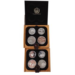 Seven Royal Canadian Mint 1976 'Montreal Olympics' silver proof four coin sets, each containing two five dollar and two ten dollar coins, each cased and boxed with certificates