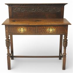 Early 20th century oak side table, raised back with carved detail, above pair of drawers w...