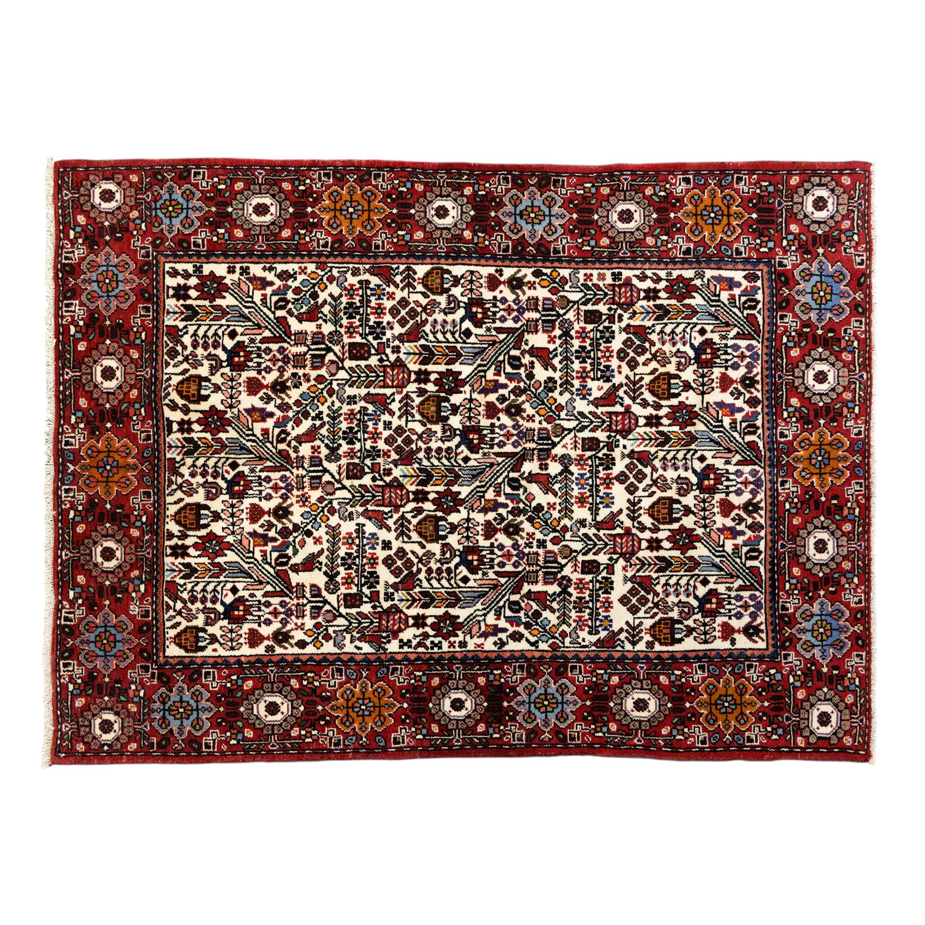 North west Persian Rudbar hand-knotted rug, ivory field woven with a repeating pattern of stylized shrubs, rosettes, and geometric floral motifs in tones of madder red, turquoise, indigo, and ochre, enclosed by a border of linked rosettes and angular flowerheads between narrow guard stripes 