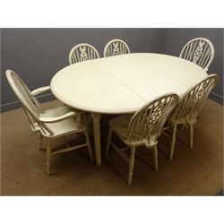  Painted circular extending dining table, turned supports, one leaf and six wheel back chairs (4+2), W164cm, H74cm, D116cm (maximum measurements)  