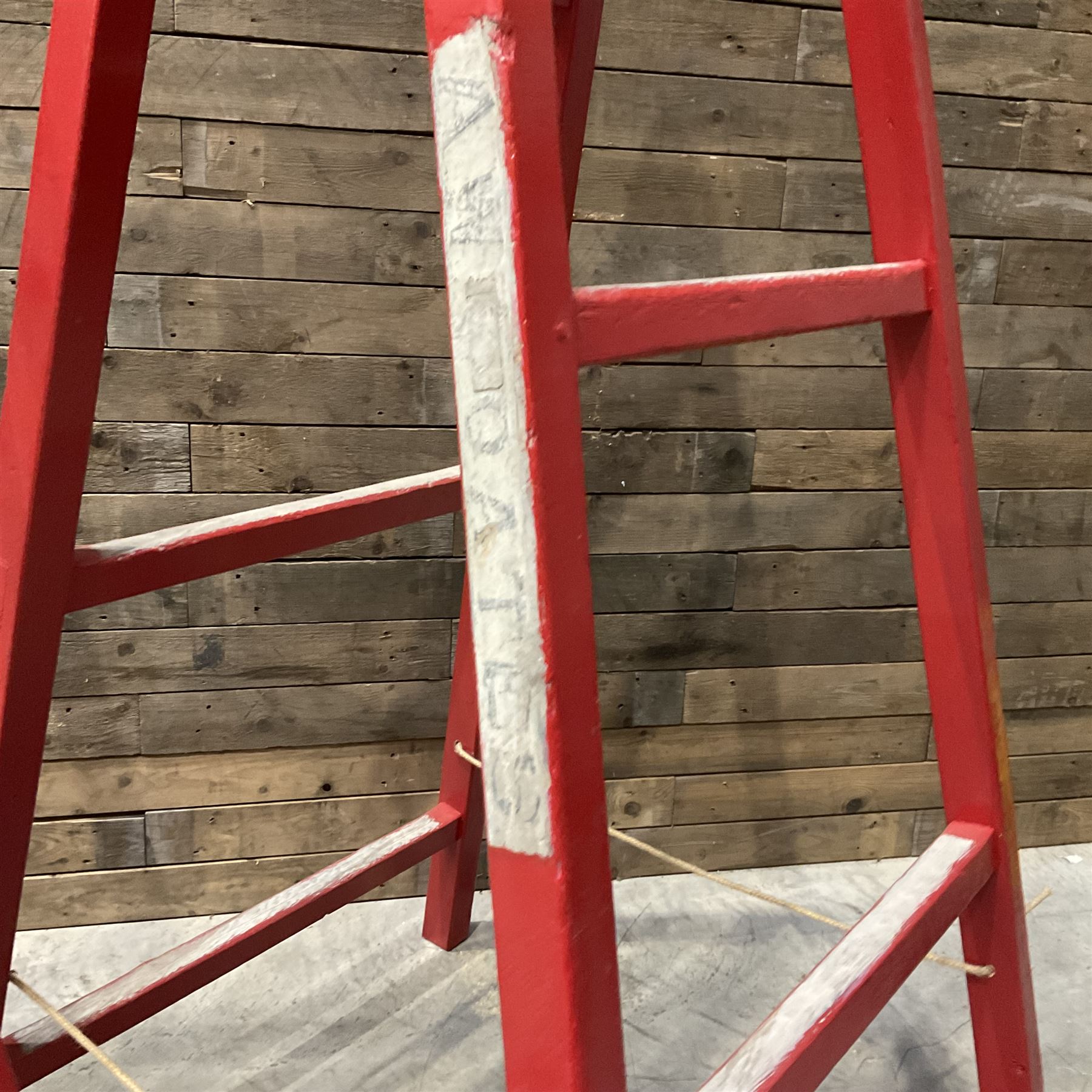 Pair of vintage red painted A frame trestles, with original A W Oates Painter signage