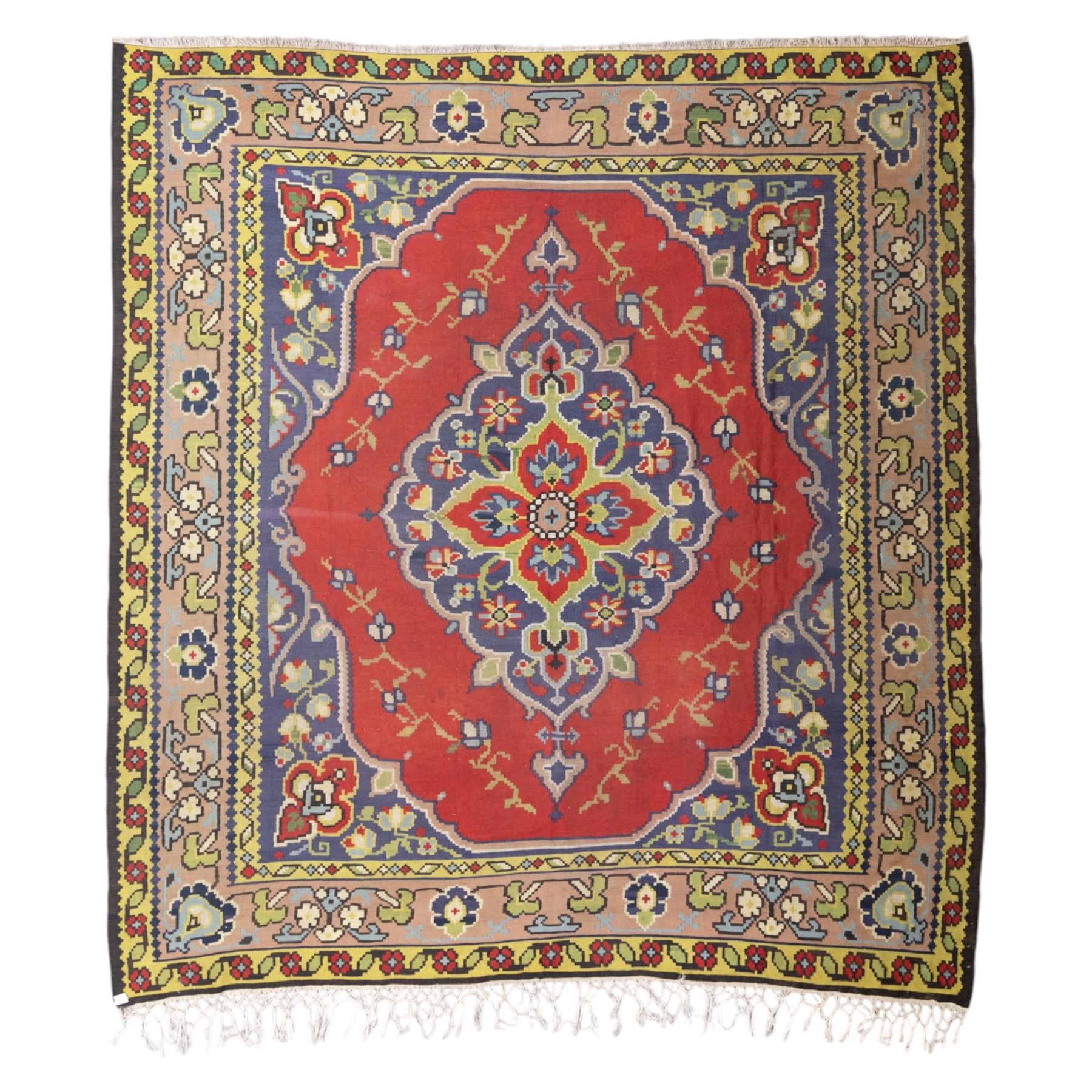 Turkish Malatya type flatwoven rug, decorated with a red medallion field, stylised floral motifs and blue corner panels, enclosed by beige foliate border and outer floral guard band