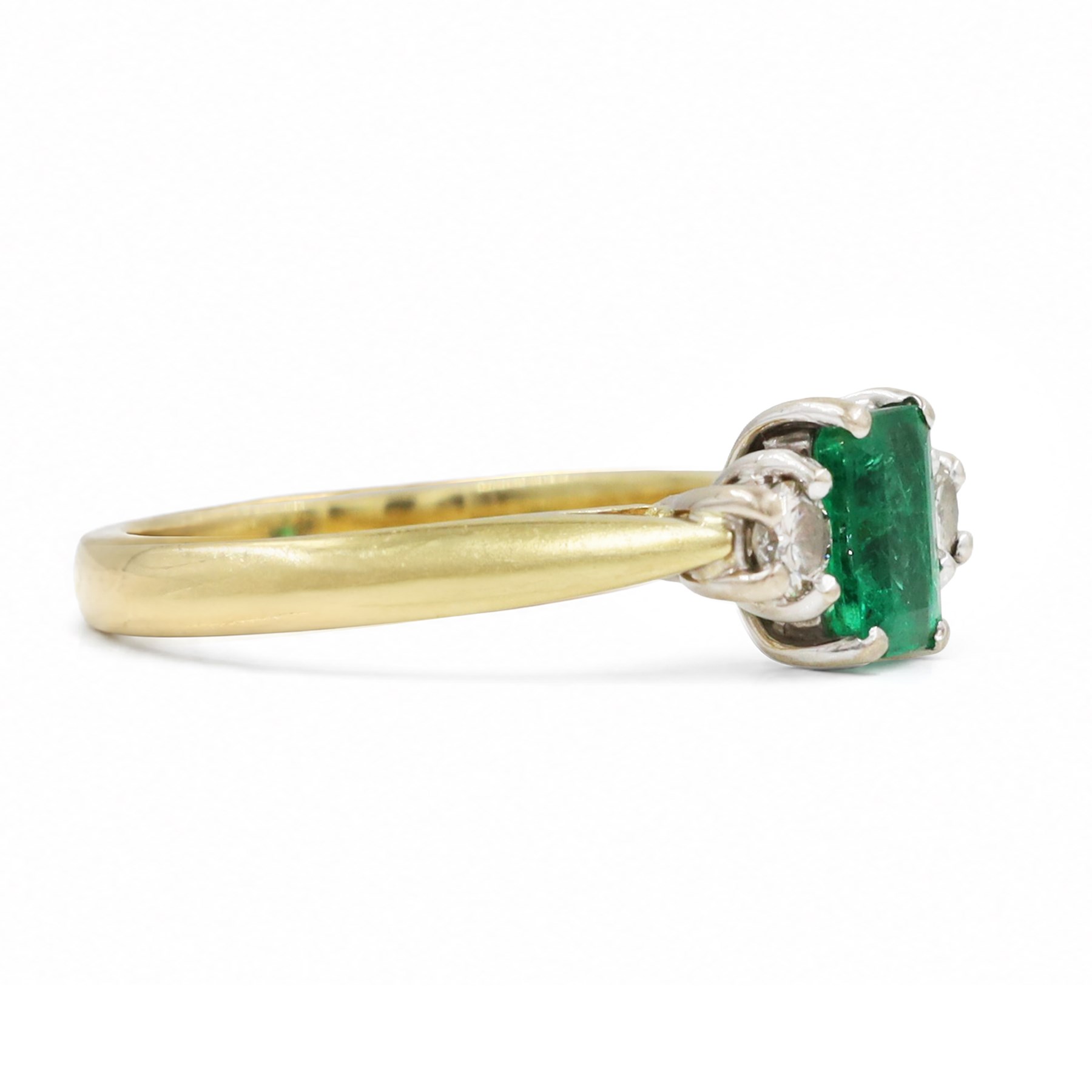 18ct gold emerald and diamond three stone ring, single octagonal cut emerald of approx 0.40 carat, with a round brilliant cut diamond set either side, Birmingham 1997, total diamond weight approx 0.15 carat