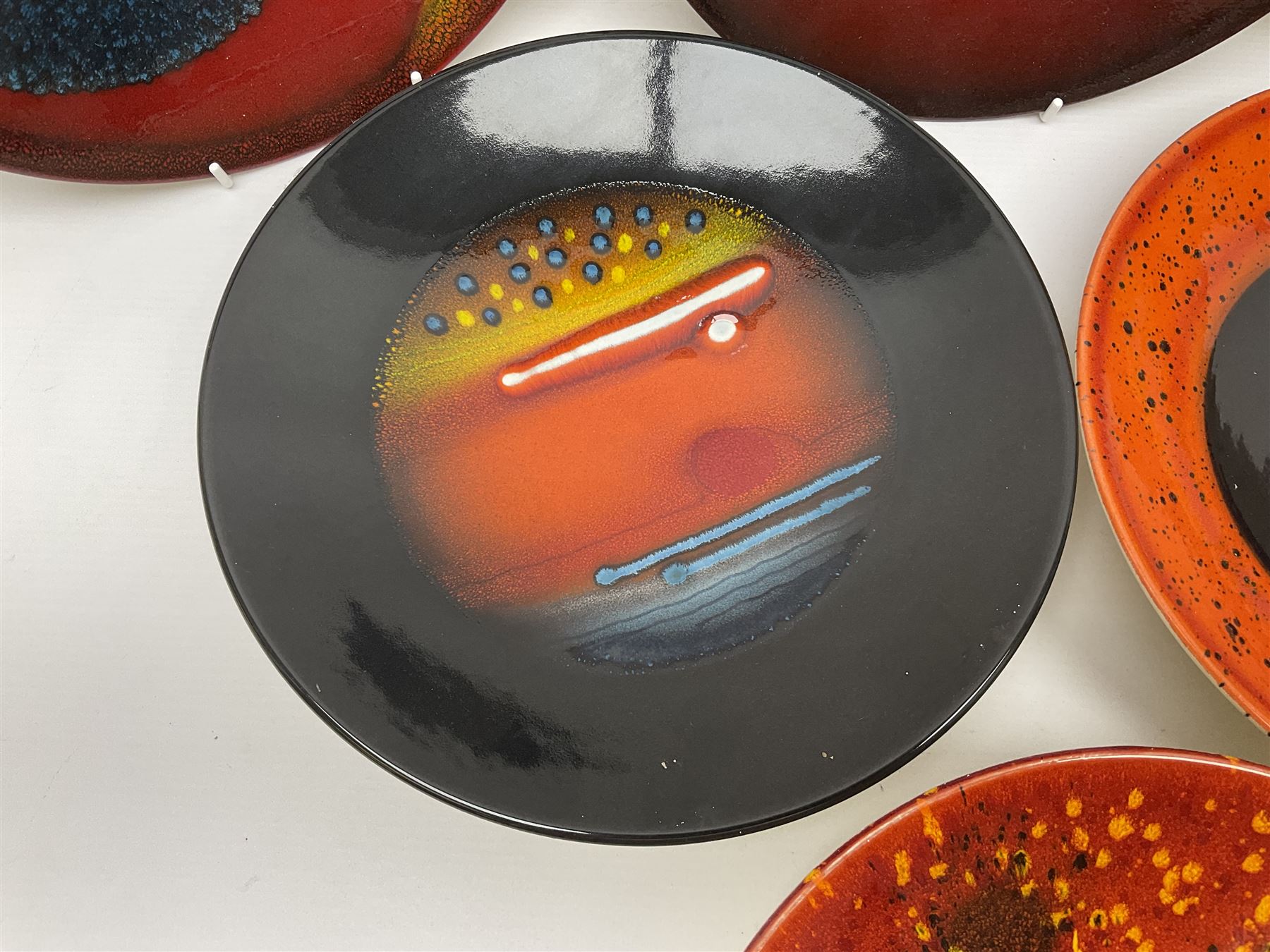 Poole Pottery The Planets, set of nine chargers 'The Planets, by Alan Clarke, comprising Mars, Mercury, Neptune, Venus, Uranus, Pluto, Jupiter, Saturn and Earth, all with original boxes and certificate, D27cm 