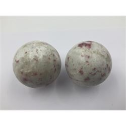 Pair of cinnabar spheres, upon gilt metal stands, H9cm D6cm 