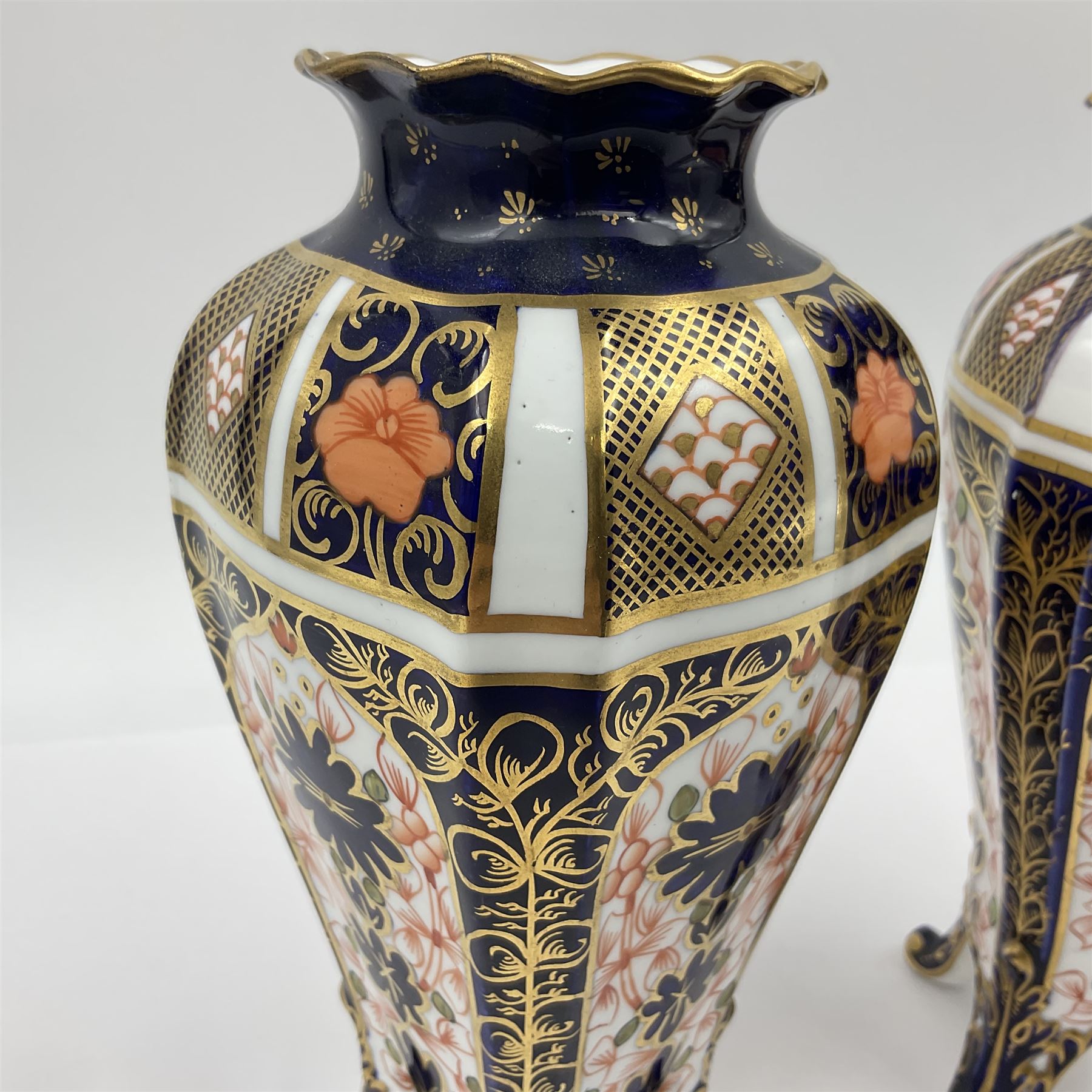 Pair of early 20th century Royal Crown Derby Imari 1128 pattern vases, of tapering straight sided form with waisted neck and frilled rim, upon four splayed feet, with printed and painted marks beneath including illustration date codes for 1911 and 1920, H17cm